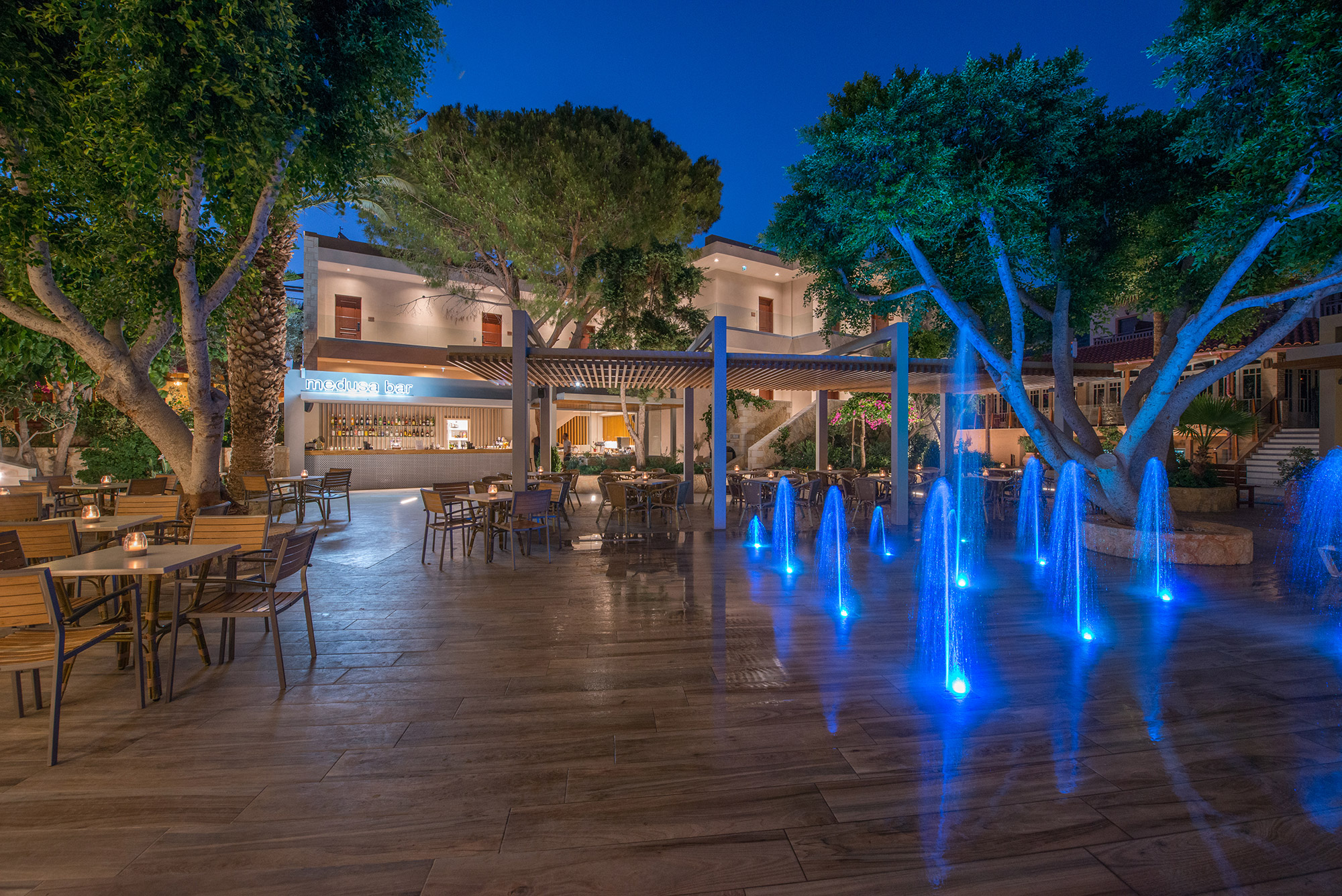 open bar area with a fountain that has neon lights
