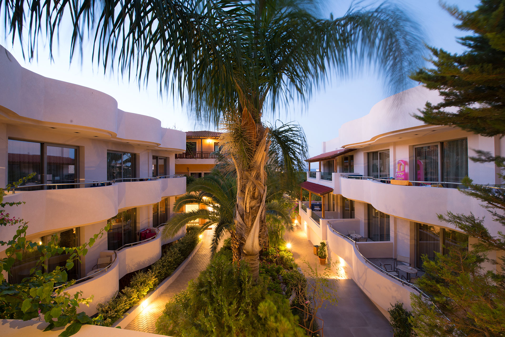 Hotel room balconies overlooking palm trees