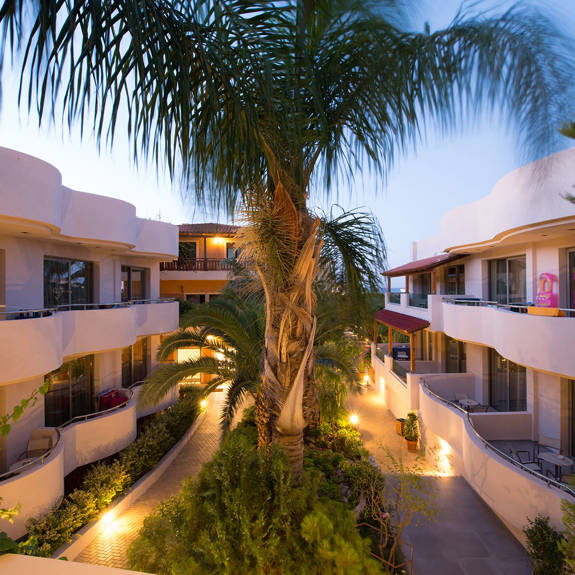 Hotel room balconies overlooking palm trees